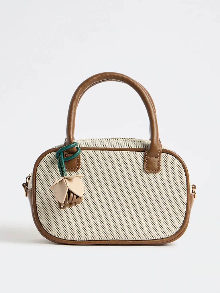 Westside Off-White Textured Sling Bag with a Floral Bag Charm